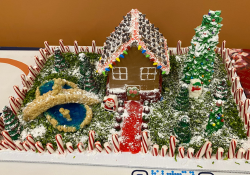 A charming gingerbread village scene with a colorful candy-coated house, snowmen, and trees,